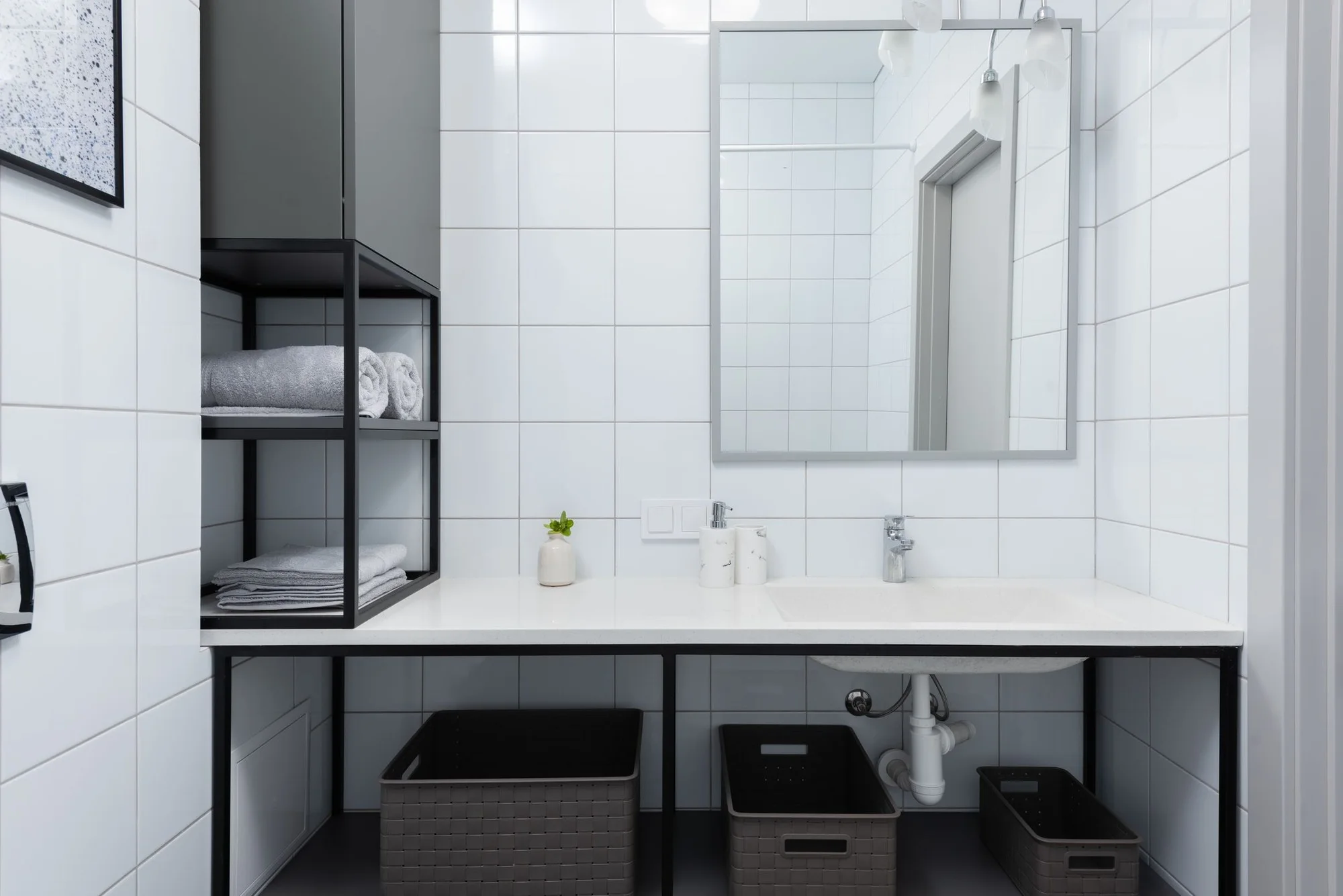 Clean, bright white-tiled bathroom