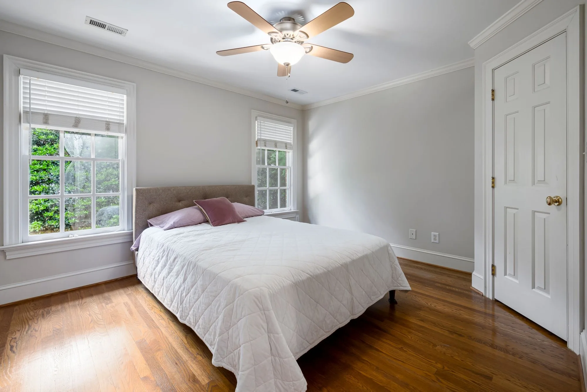 Clean, made-up bedroom with a garden view